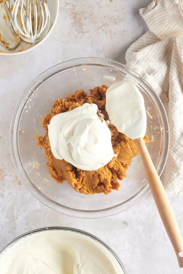 overhead view of whipped cream added to mixed cream cheese, peanut butter, and confectioners' sugar