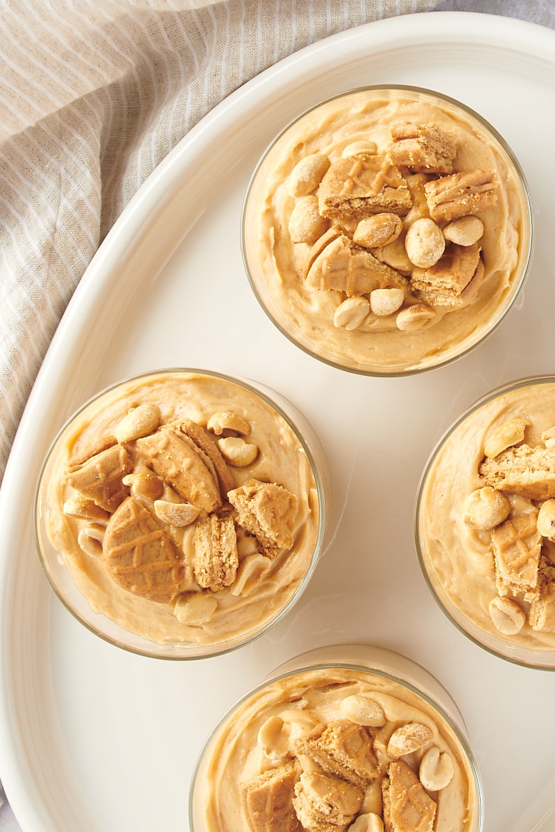 overhead view of servings of Peanut Butter Mousse in clear glasses on a white tray