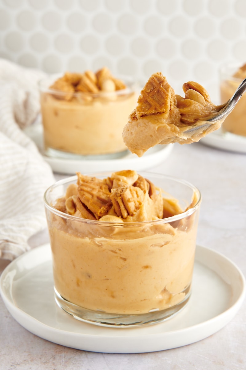 a spoonful of Peanut Butter Mousse over a glass filled with more mousse