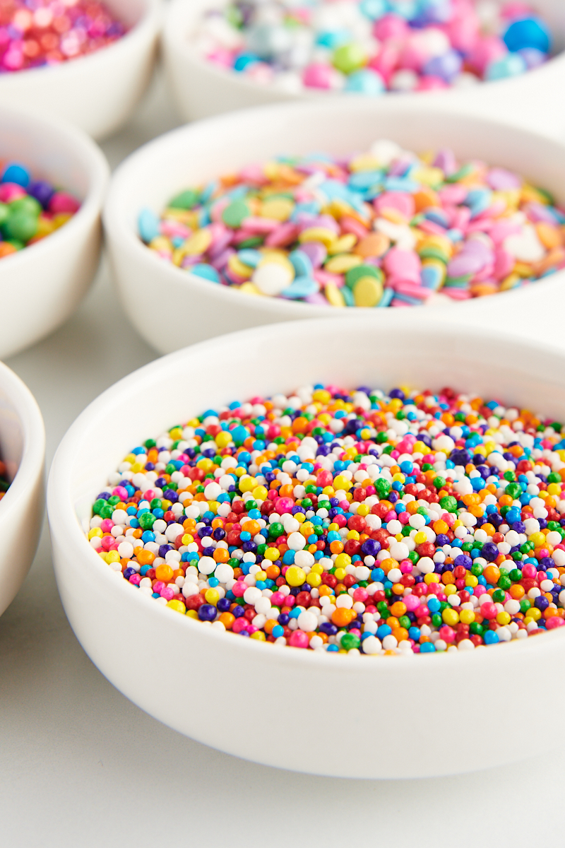 white bowls filled with brightly colored sprinkles