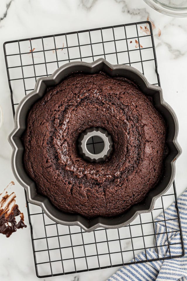 Overhead view of chocolate sour cream Bundt cake in pan on rack