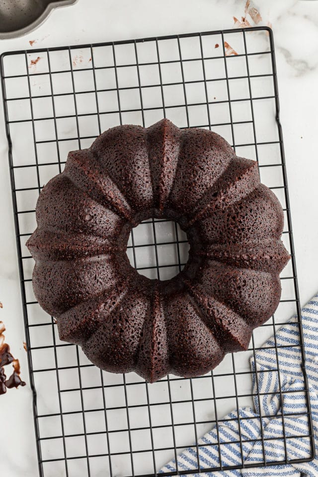 Overhead view of chocolate bundt cake cooling on rack