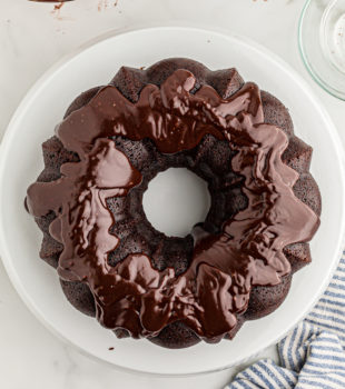 Overhead view of glazed chocolate sour cream Bundt cake on cake stand