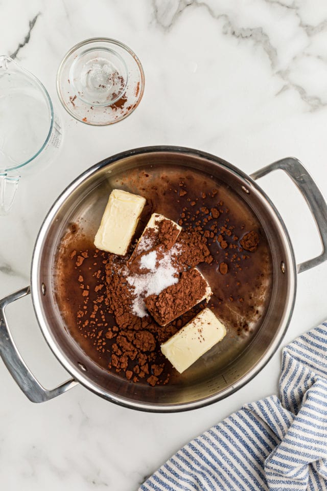 Overhead view of butter, cocoa powder, and salt in pan