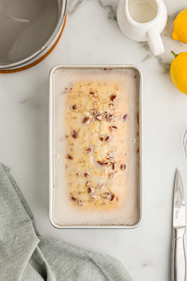 Overhead view of lemon bread in pan with glaze