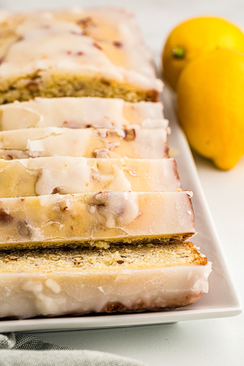 Sliced glazed lemon bread on serving tray