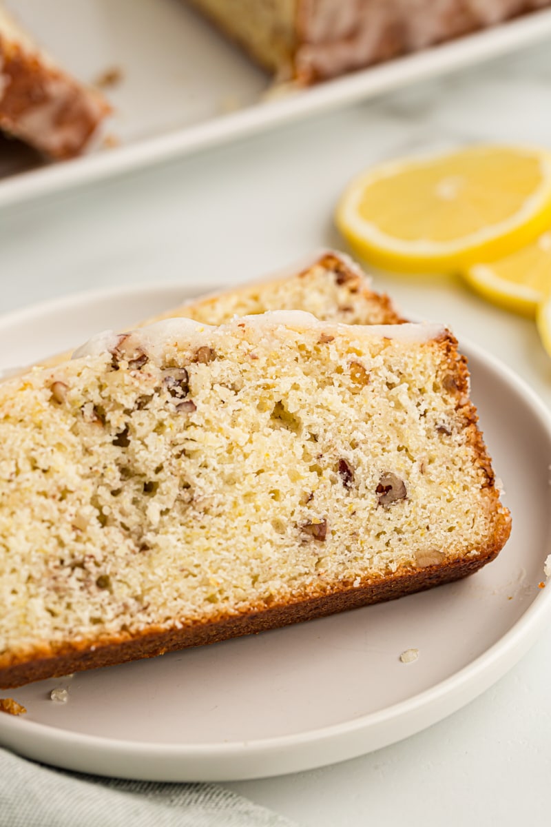 Two slices of lemon bread on white plate