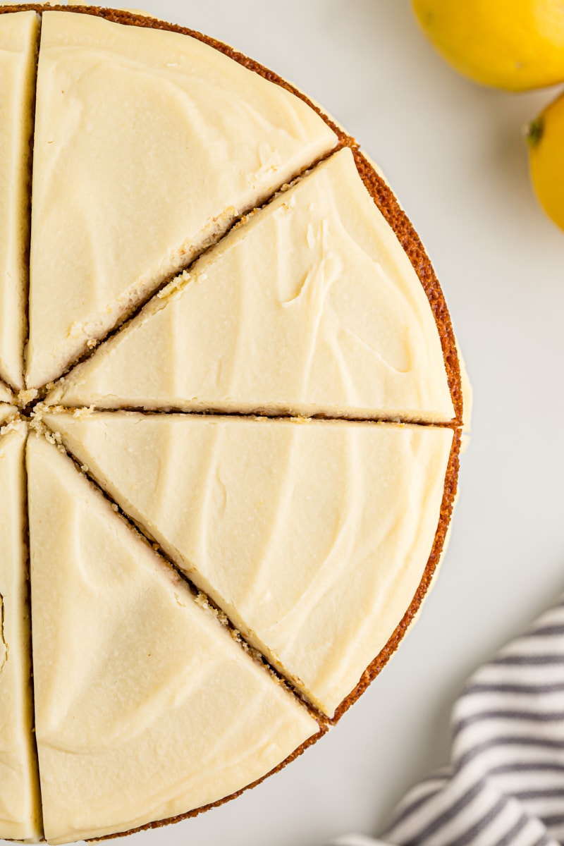 Overhead view of whole lemon cream cake cut into slices