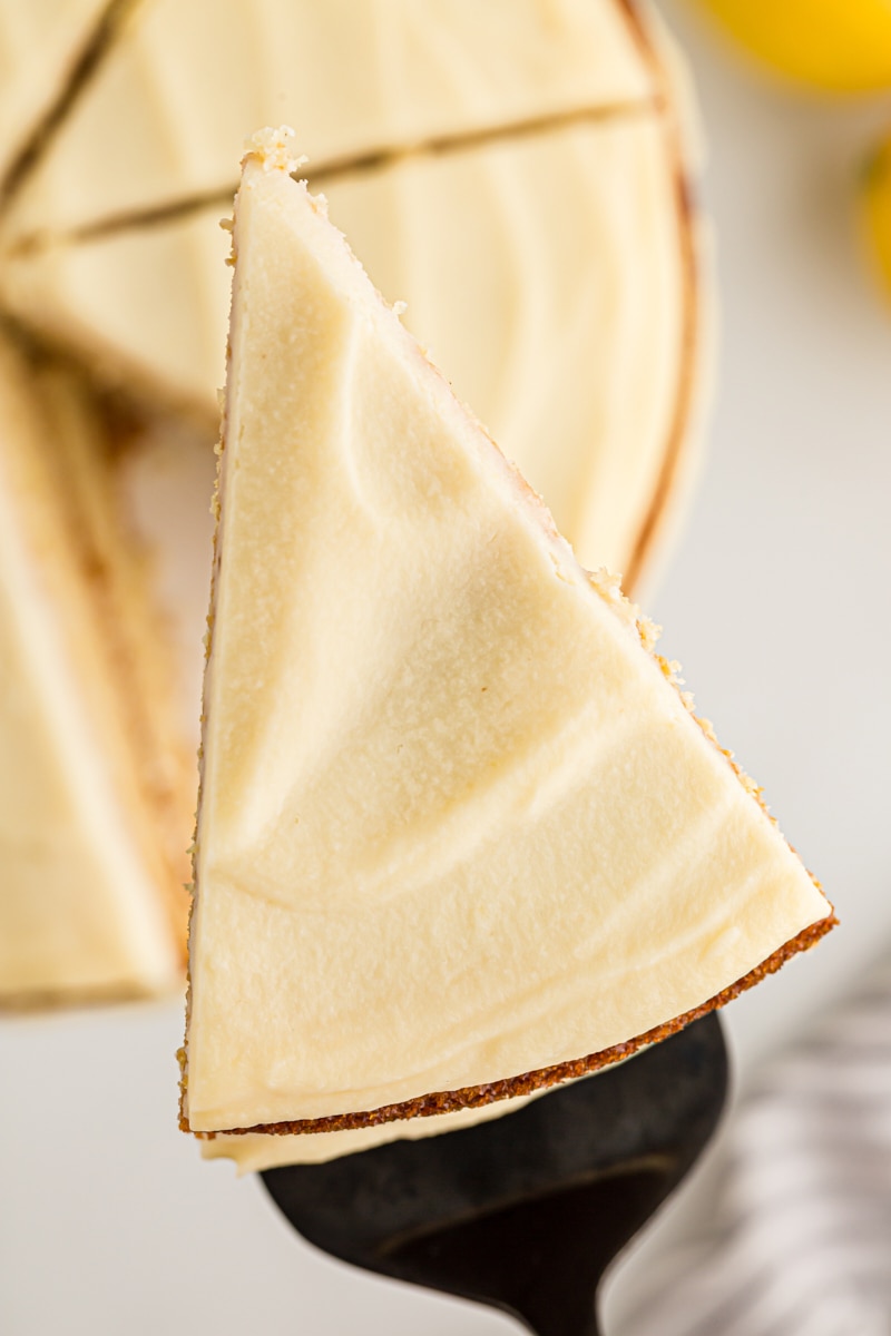 Overhead view of slice of lemon cream cake on spatula