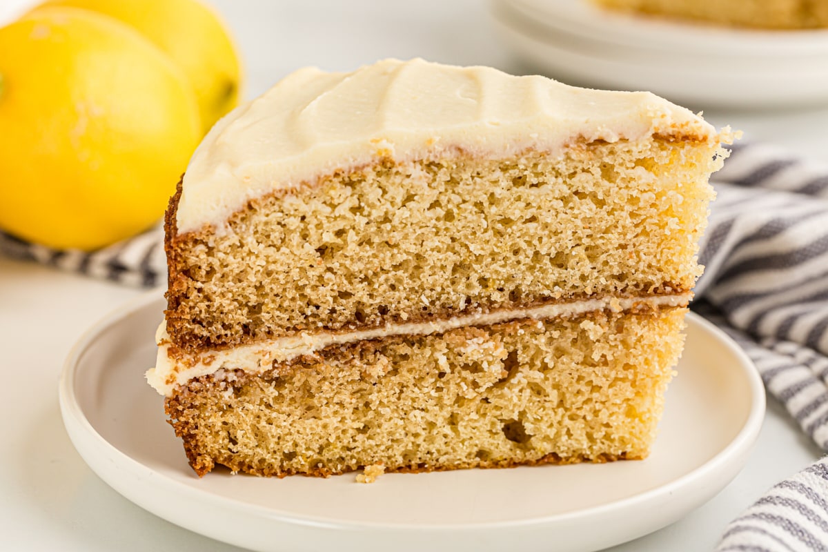 Side view of slice of lemon cream cake on plate