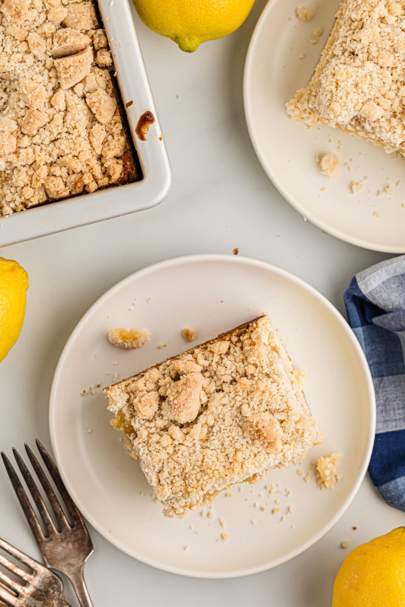 Overhead view of lemon yogurt crumb cake on 2 plates and in pan