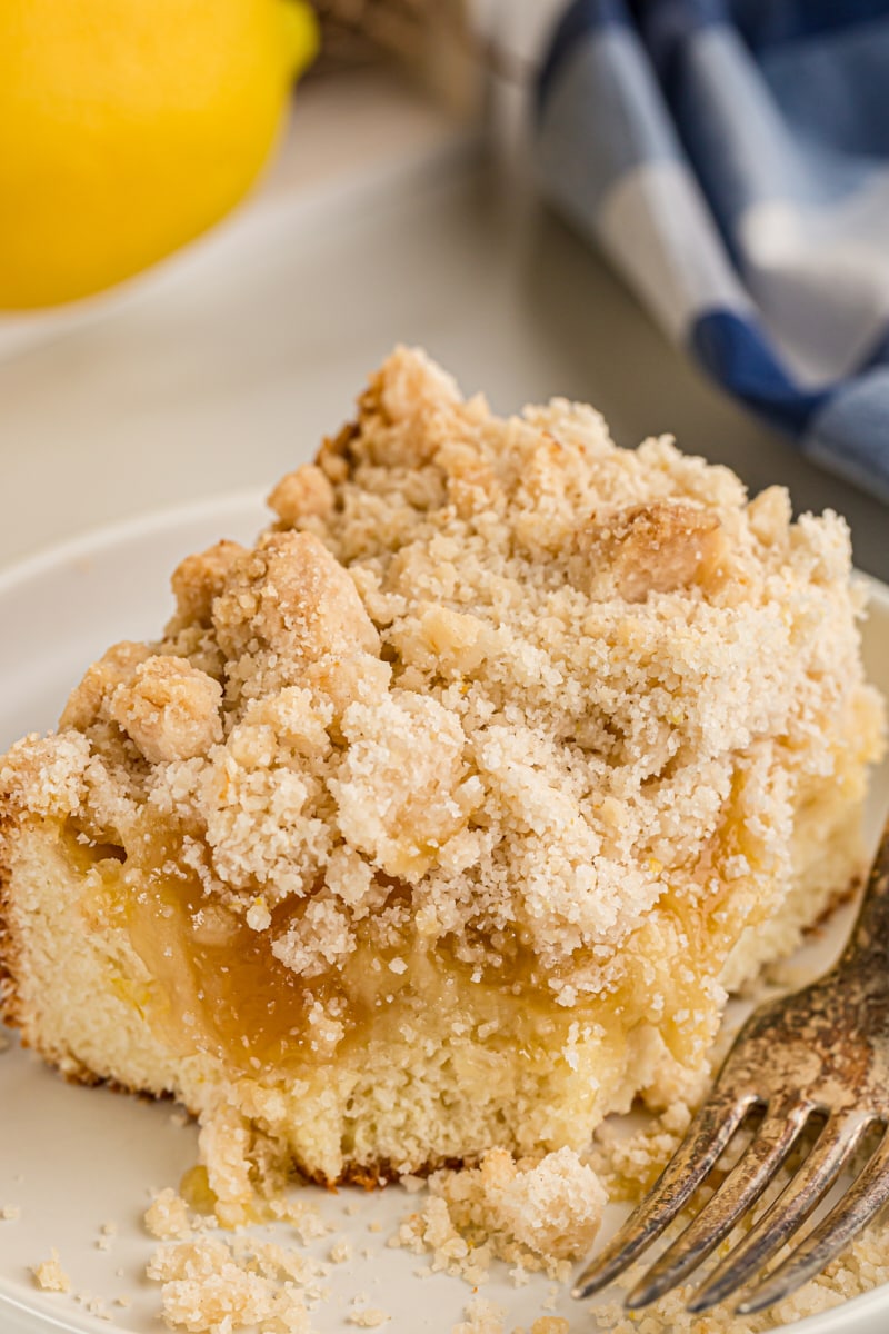 Piece of lemon yogurt crumb cake on plate with fork