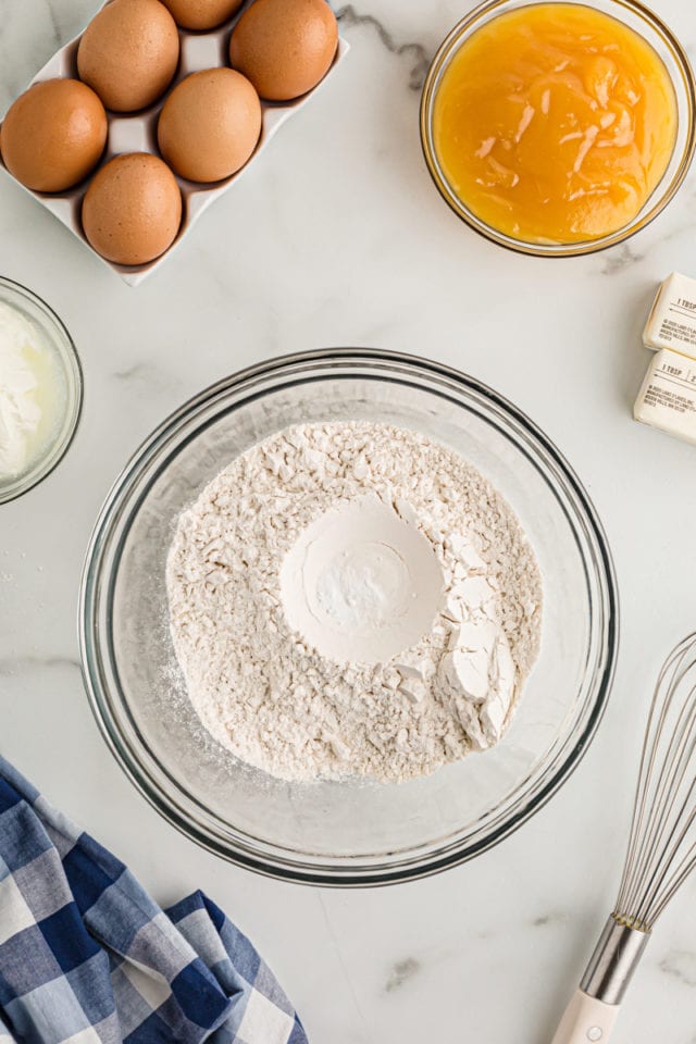 Overhead view of dry cake ingredients in glass bowl