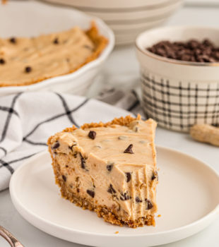 Peanut butter chocolate chip pie on plate with tip removed