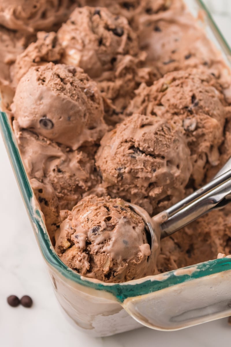 several scoops of rocky road ice cream in a glass pan