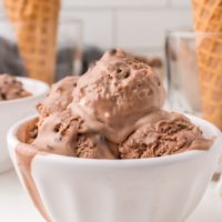 several scoops of rocky road ice cream in a white bowl