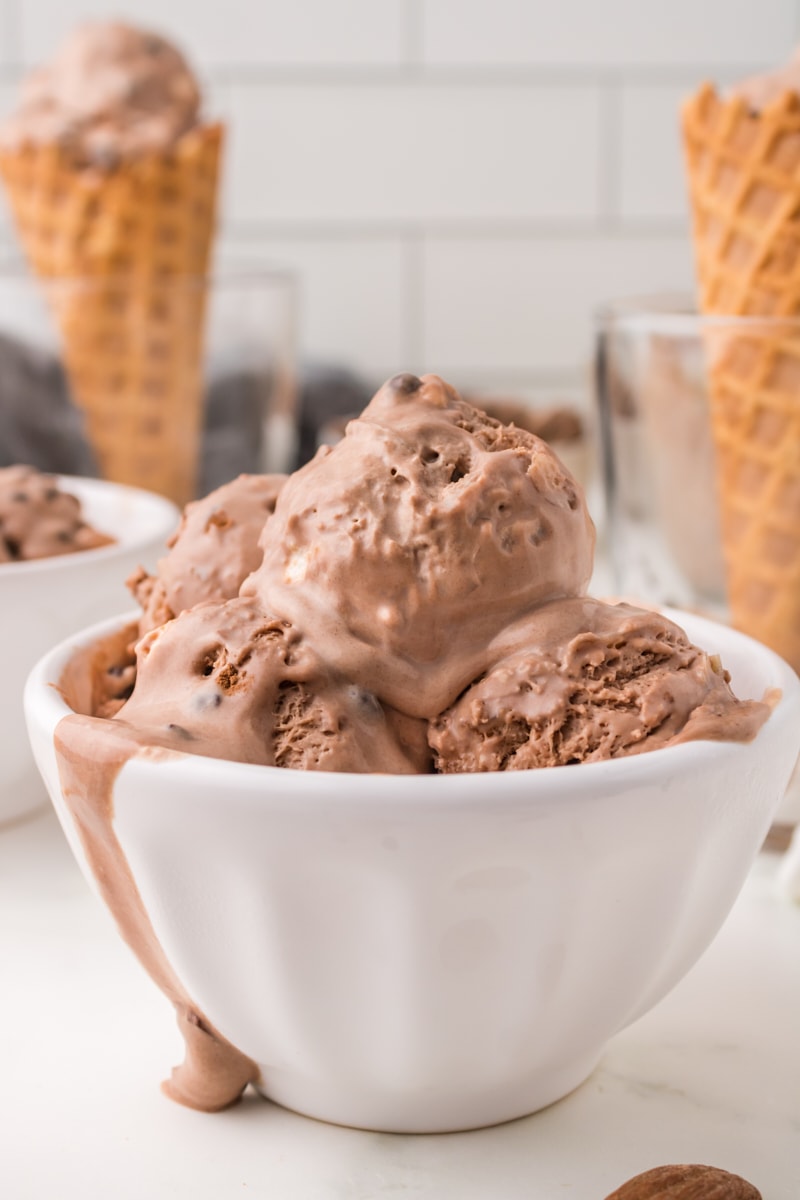 several scoops of rocky road ice cream in a white bowl