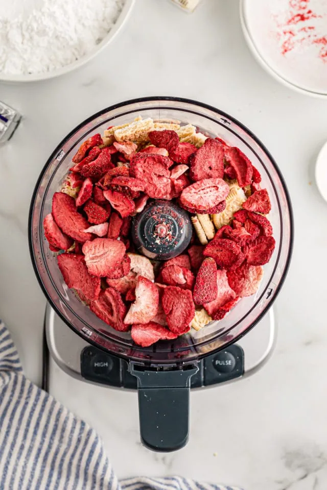 Overhead view of strawberries and cookies in food processor