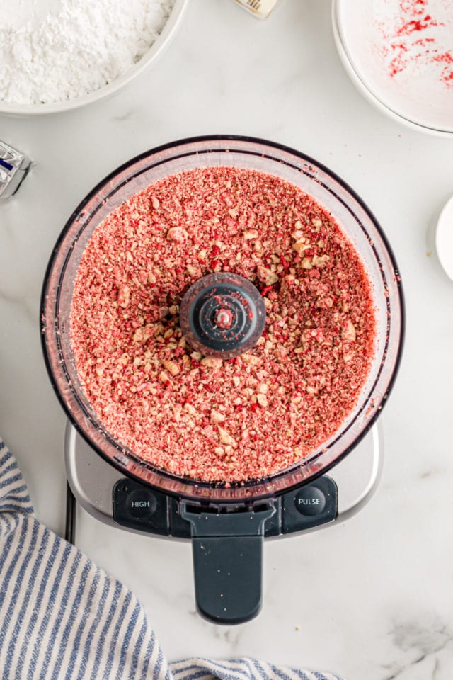 Overhead view of strawberry crunch mixture in food processor