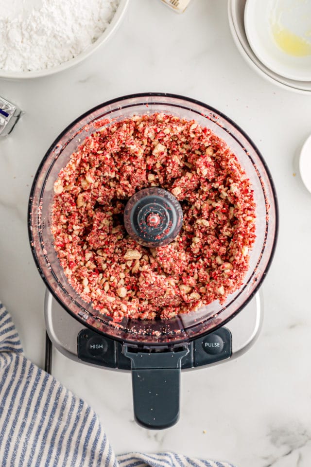 Overhead view of strawberry crunch mixture in food processor