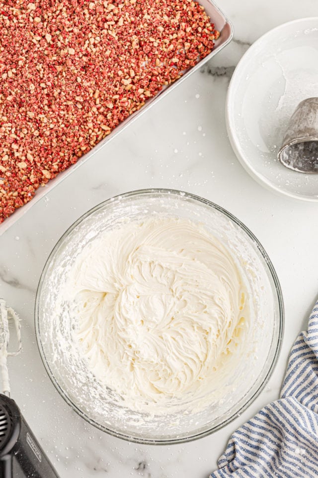 Overhead view of cream cheese frosting in mixing bowl