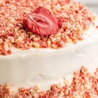 Closeup of strawberry crunch cake with strawberry on top