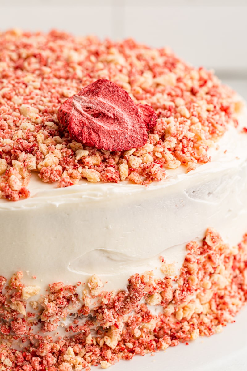 Closeup of strawberry crunch cake with strawberry on top