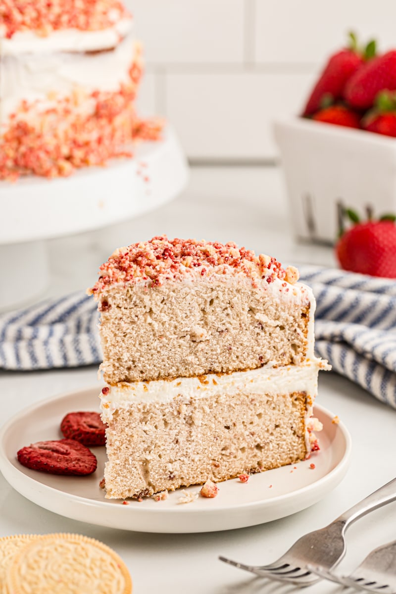 Slice of strawberry crunch cake on white plate