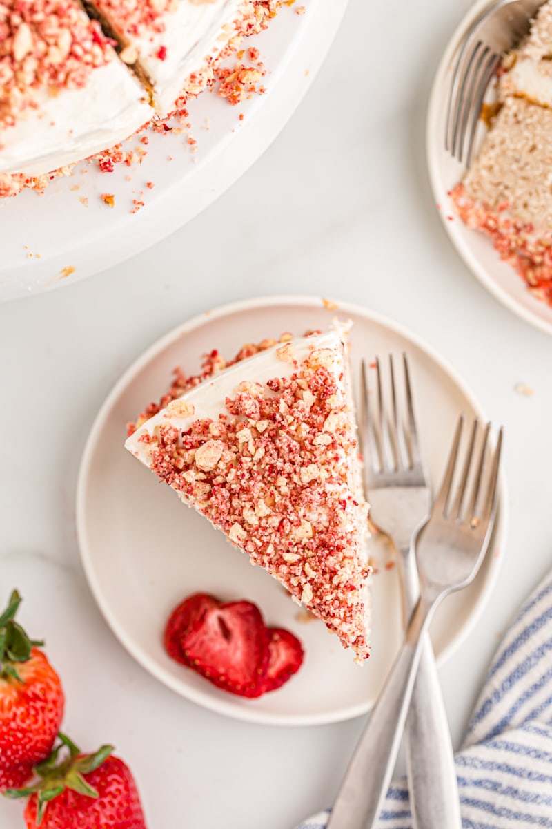 Overhead view of strawberry crunch cake slice on plate