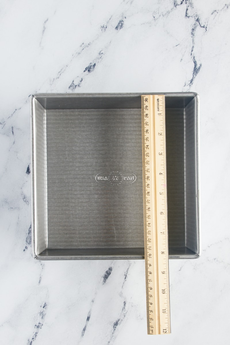 overhead view of a ruler on top of a square baking pan