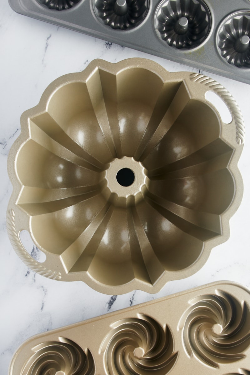 overhead view of a classic Bundt pan with a mini Bundt pan and Bundtlette pan next to it