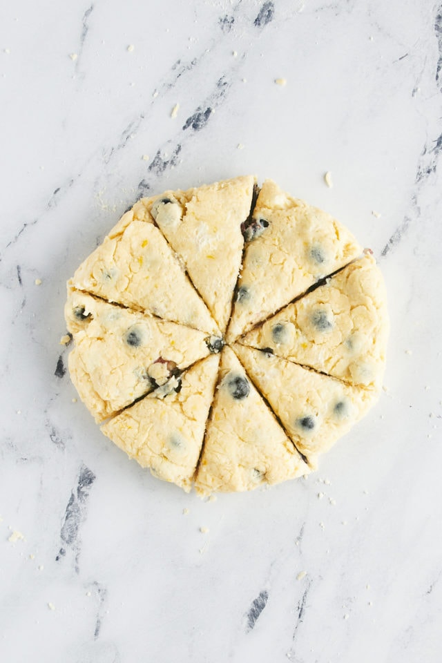 overhead view of blueberry scone dough cut into eight wedges