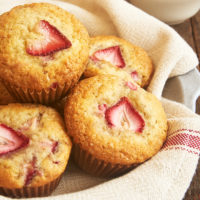 strawberry muffins in a towel-lined shallow bowl