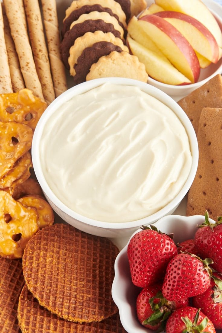 Bowl of cheesecake dip surrounded by assorted dippers