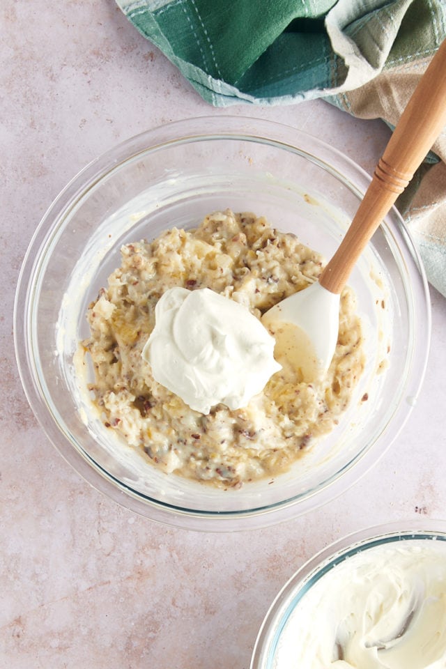 Dollop of whipped cream in mixing bowl with pie filling