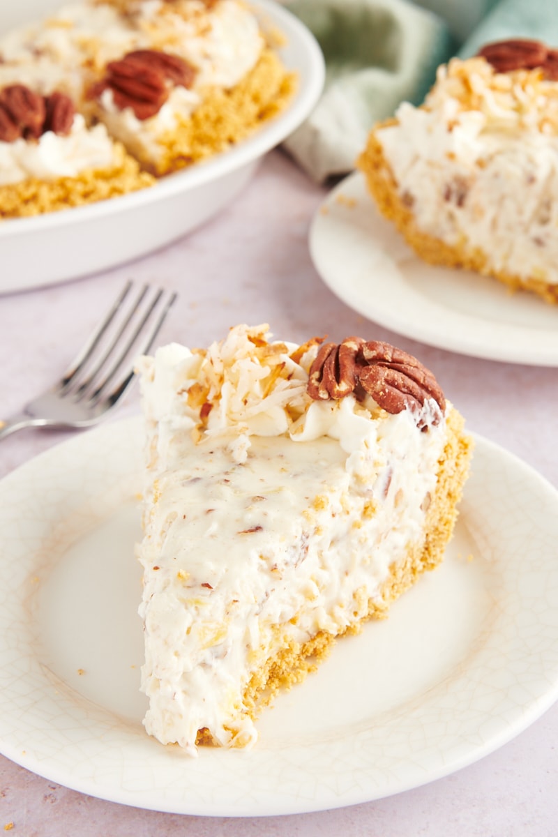 Slice of millionaire pie on plate with remaining pie in background