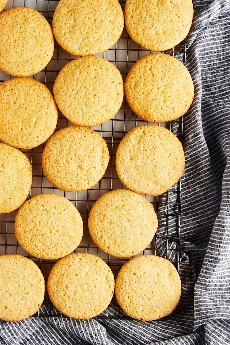 Overhead view of tea cakes cooling on a wire rack.