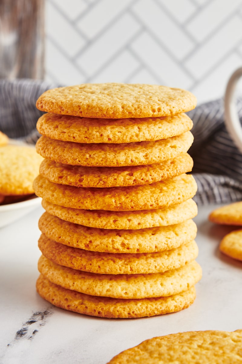 A tall stack of tea cakes on a marble surface.