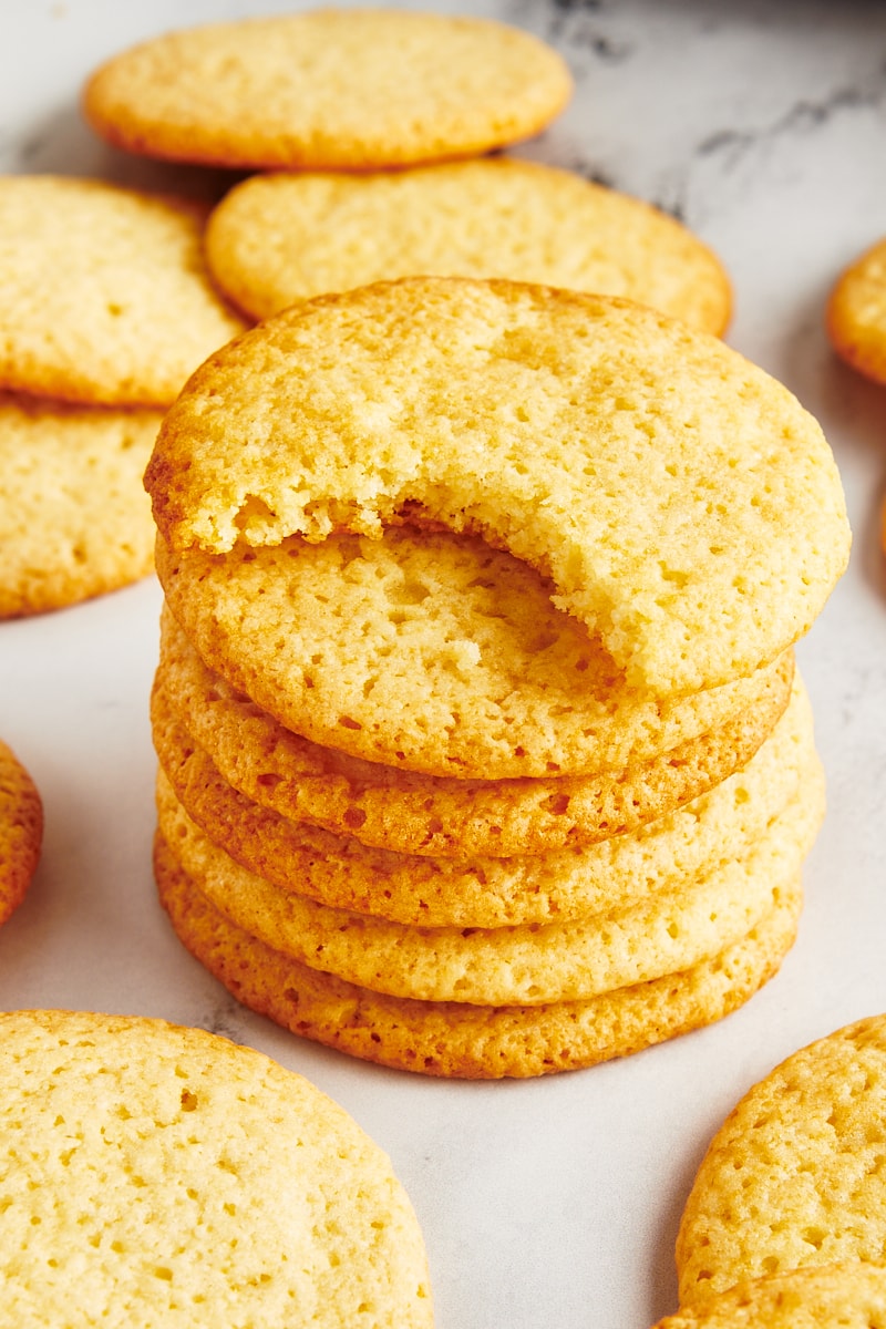 A stack of tea cakes with the cookie on top missing a bite.