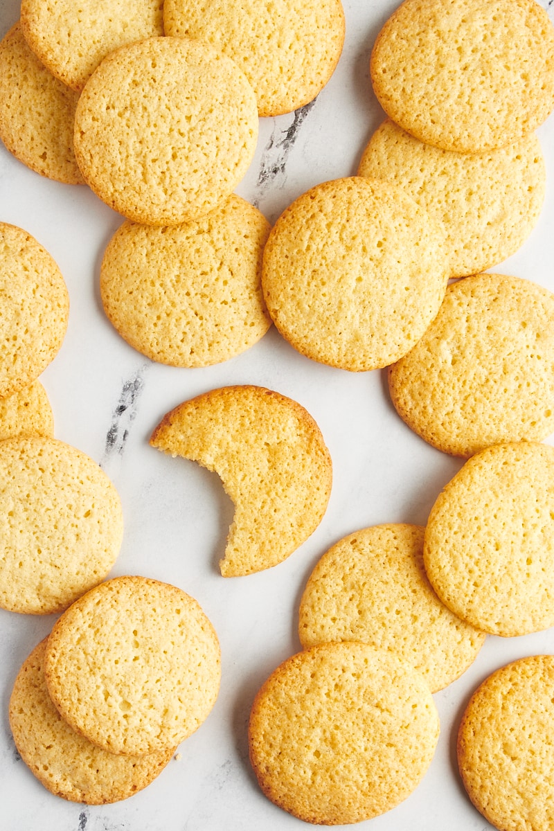 Overhead view of tea cakes scattered on a marble surface.