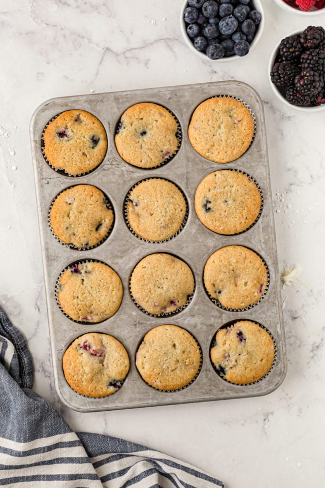 overhead view of freshly baked berry cupcakes in a muffin pan