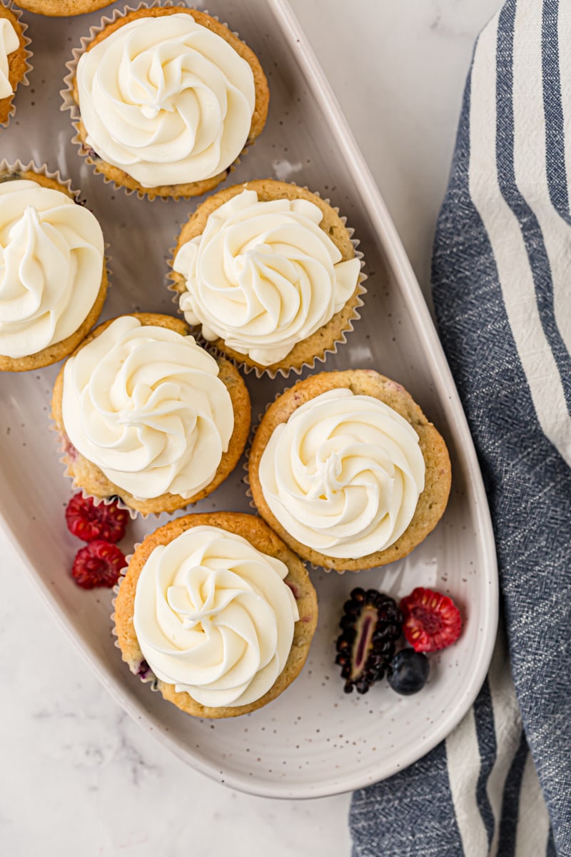 overhead view of berry cupcakes on a white tray