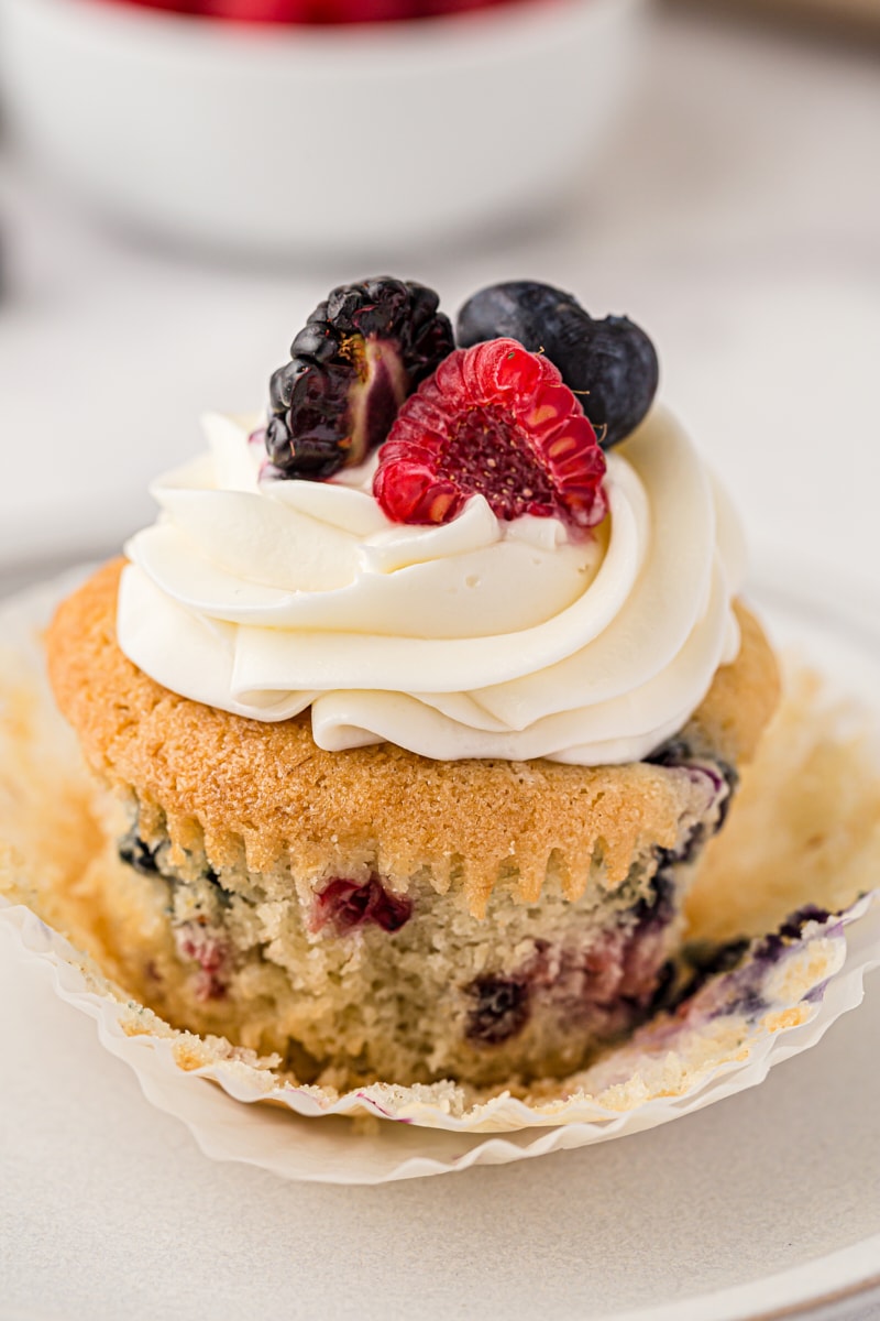 close up of a berry cupcake with the wrapper partially removed