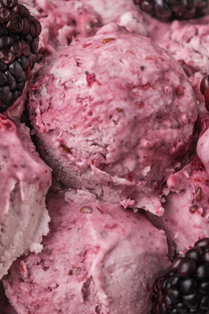 close-up of several scoops of blackberry ice cream