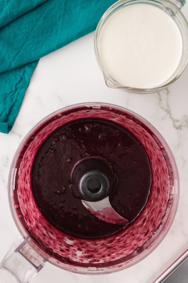 overhead view of blackberry puree in the bowl of a food processor