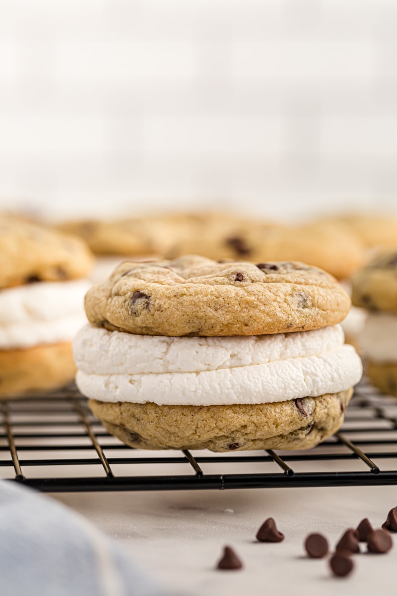 close up of a Chocolate Chip Cookie Sandwich on a wire rack with more cookies in the background