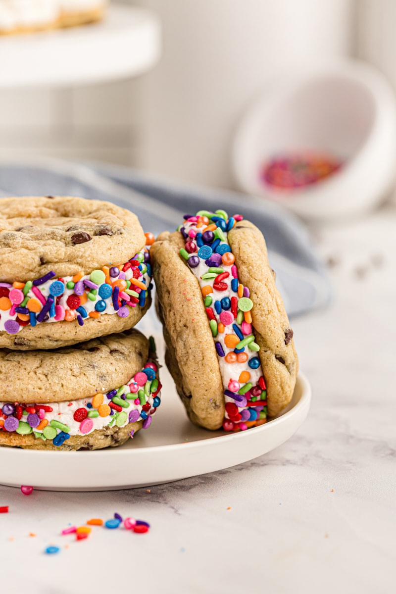 three Chocolate Chip Cookie Sandwiches garnished with sprinkles and served on a gray plate