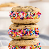 a stack of three Chocolate Chip Cookie Sandwiches on a light gray plate