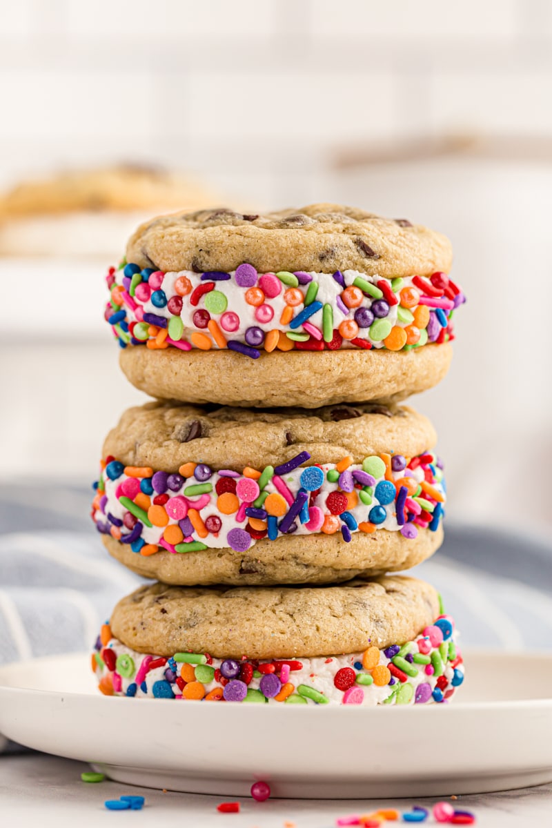 a stack of three Chocolate Chip Cookie Sandwiches on a light gray plate