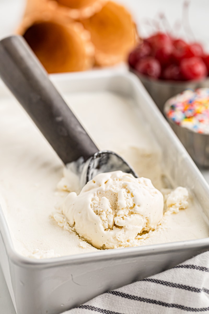 Scoop of no-churn vanilla ice cream in loaf pan